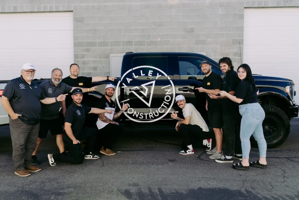 Valley Construction Team Pointing to Raptor Truck with Team Pointing to Valley Construction Logo Photo 2025